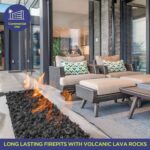 A lit gas fire pit with lava rock in an outdoor living space