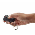 A hand holding an HPC Fire Pit Remote Control Fob