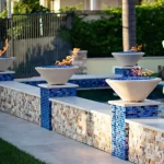 cazo fire bowls with blue fire glass in poolside location