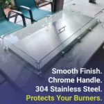 A stainless steel Fire Pit Lid on a fire pit with a glass fire pit wind guard in place