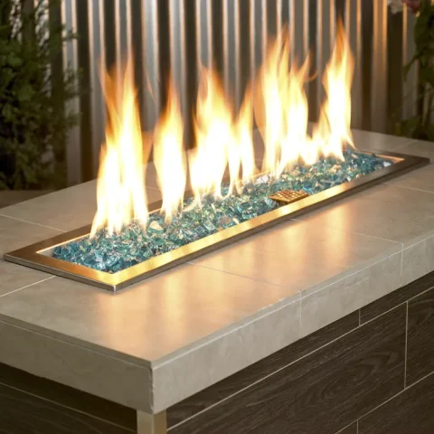 1/2 Inch Classic Fire Glass in Azuria Blue in a lit fire pit