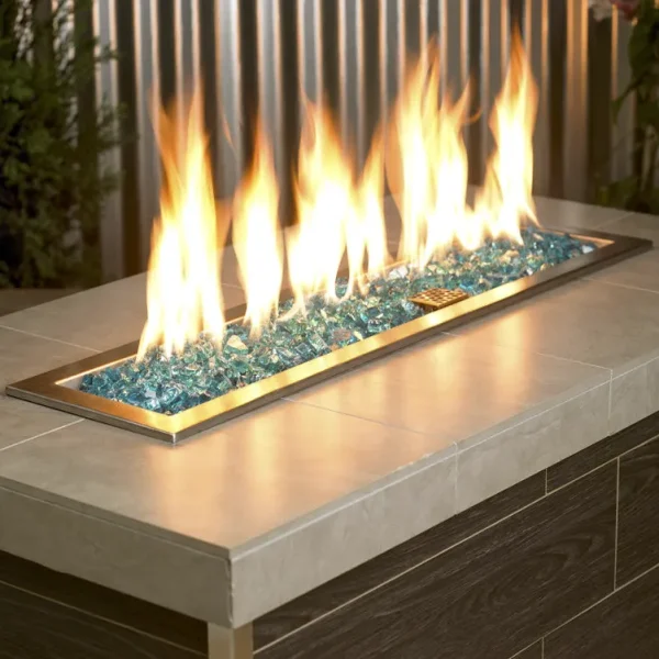 1/2 Inch Classic Fire Glass in Azuria Blue in a lit fire pit
