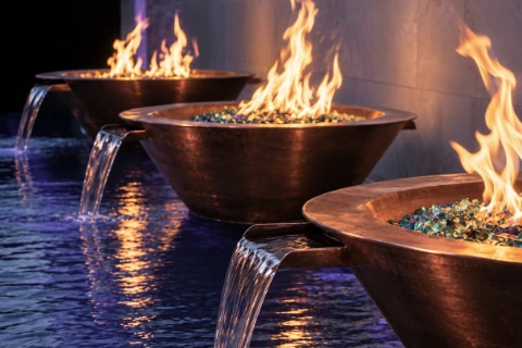 Copper Fire & Water Bowls with Scupper over Reflective Water