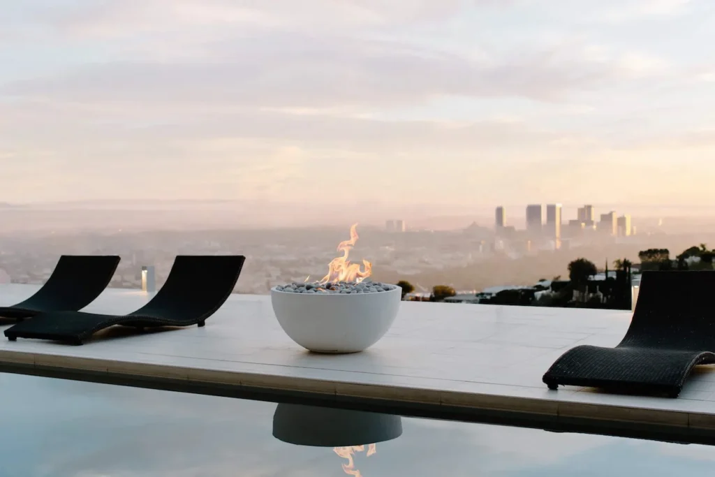 HPC Serenade lightweight concrete gas fire pit table on a modern outdoor patio