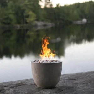 Element Lightweight Concrete Fire Pit with Beachstone Fire Media by the river