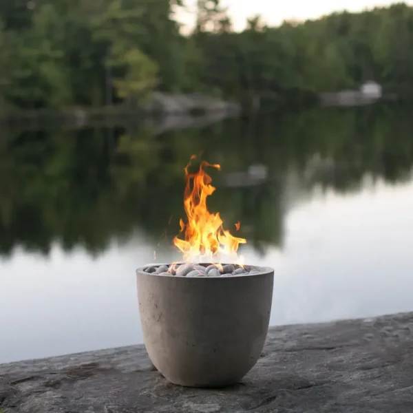 Element Lightweight Concrete Fire Pit with Beachstone Fire Media by the river