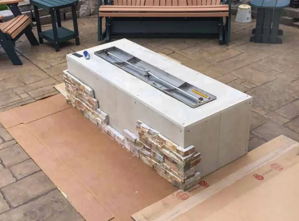 Fire Pit Enclosure Kits the image shows the process of adding cladding to the frame