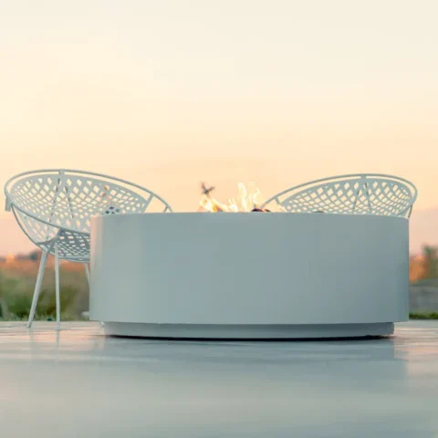 Unity Fire Pit on a patio with the sun setting behind
