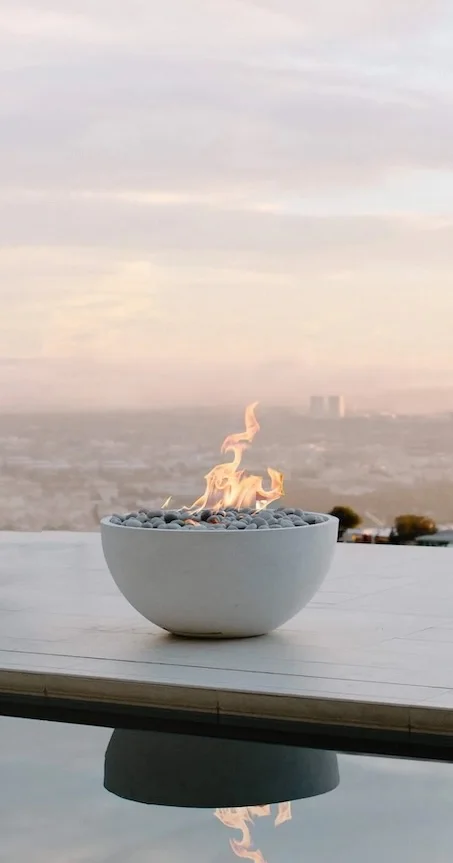 HPC Serenade lightweight concrete gas fire pit table on a modern outdoor patio