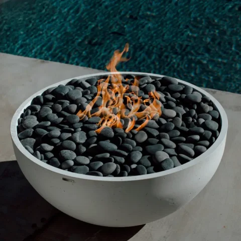 Serenade Fire Pit 40 Inch Diameter with Slate Beachstones in a poolside setting