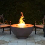 Sienna Fire Pit - GFRC Concrete in a patio setting at night