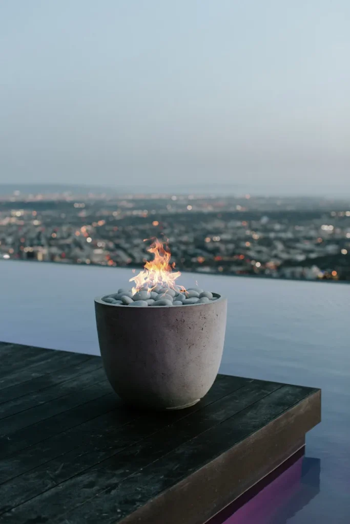 Element Fire Pit set poolside with  a commanding view over the city